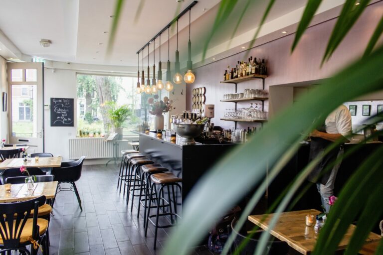 interior shot cafe with chairs near bar with wooden tables 768x512