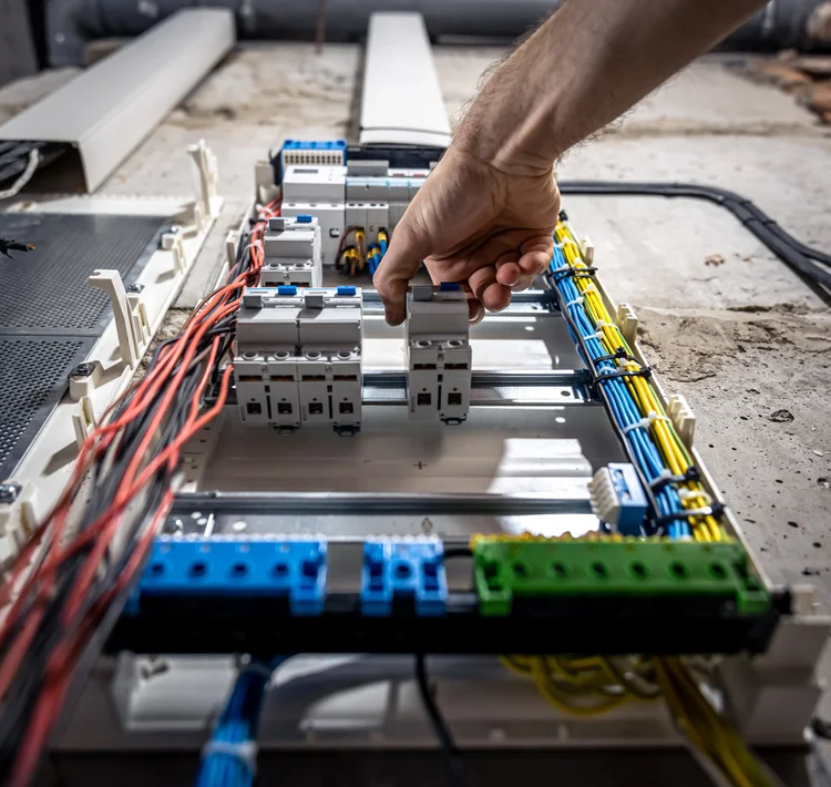 A Plus Electrical male electrician works switchboard with electrical connecting cable2