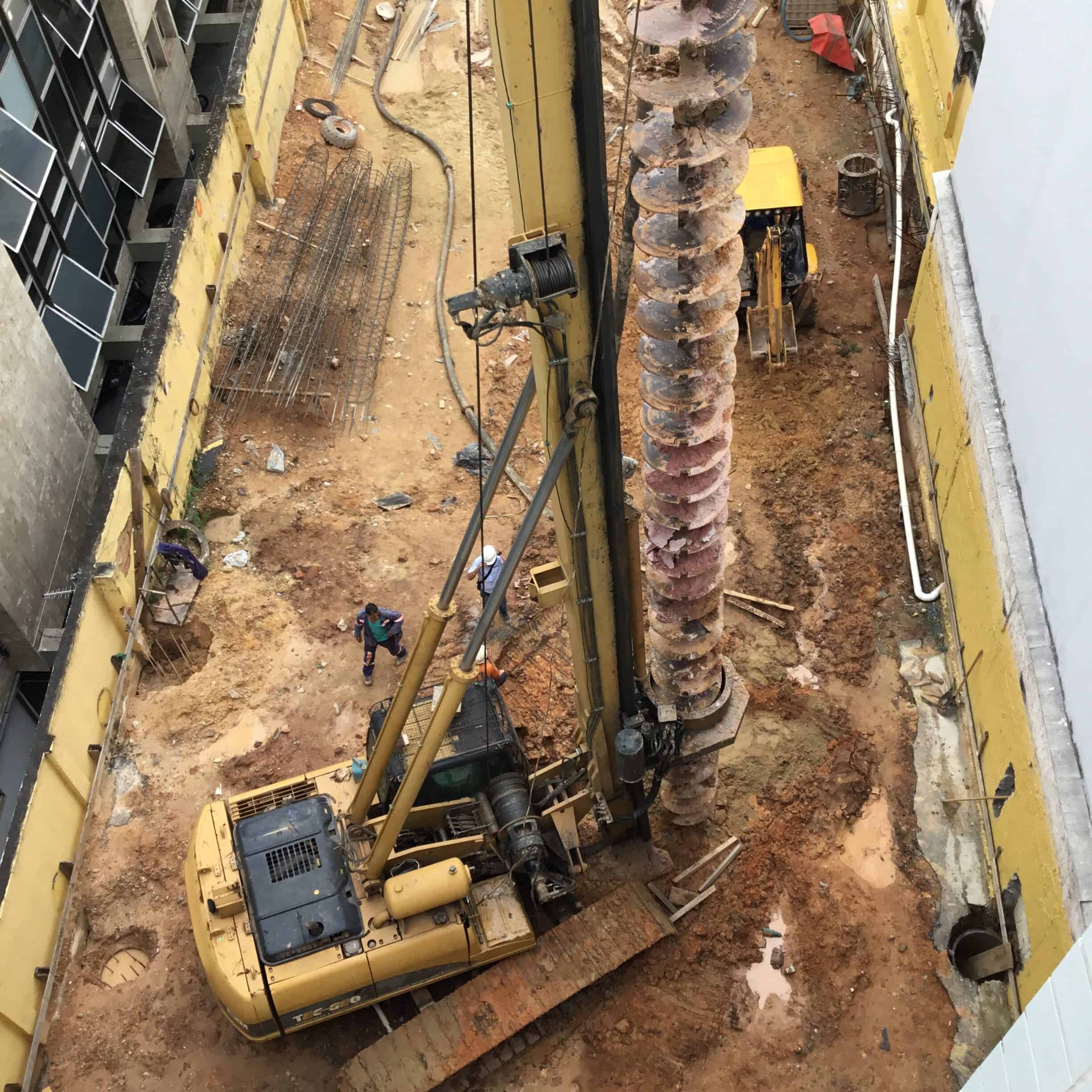 Hydraulic drilling rig boring anchor holes into a hardened concrete slab