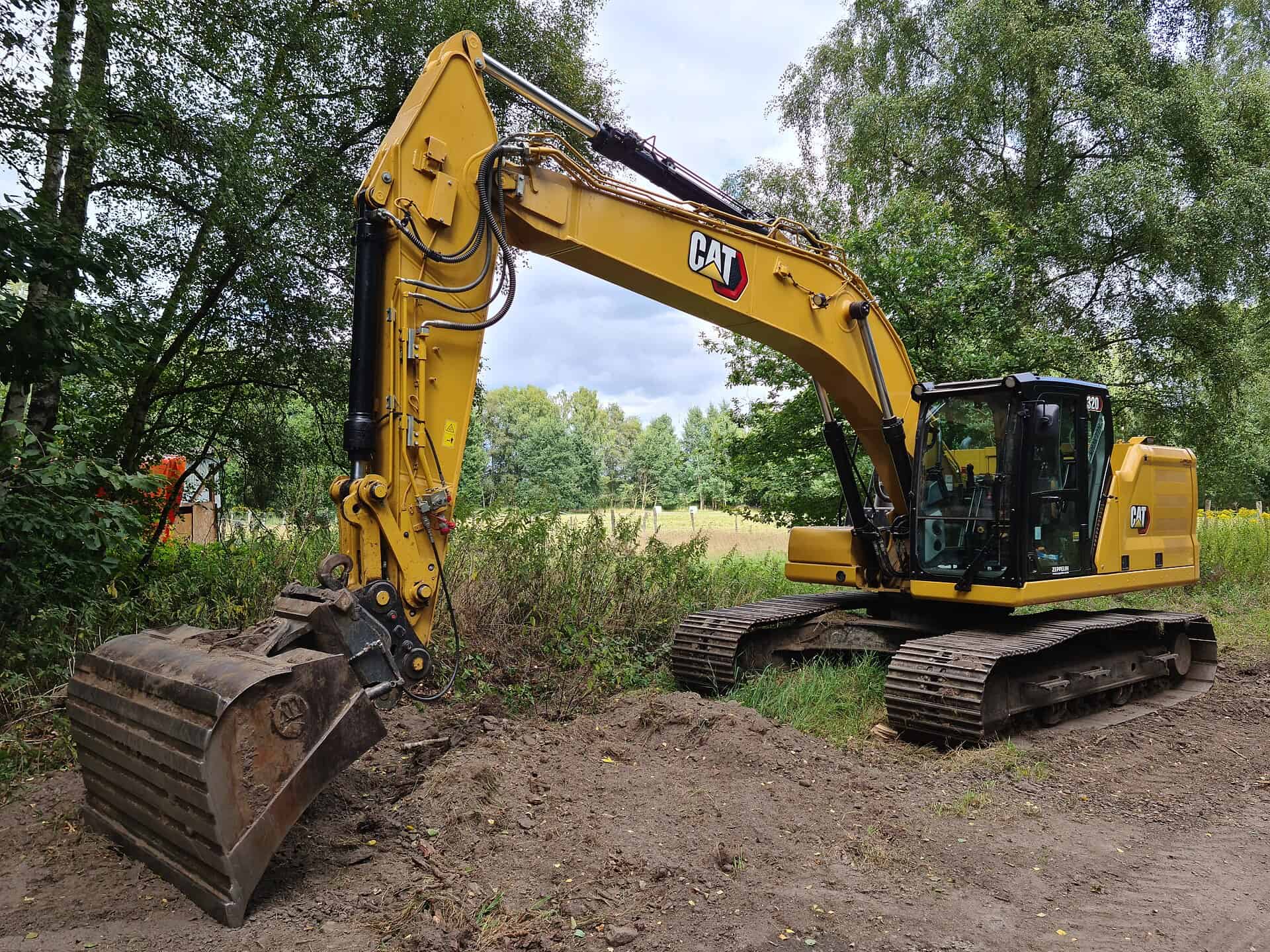 A Caterpillar crawler excavator at work on a construction site.