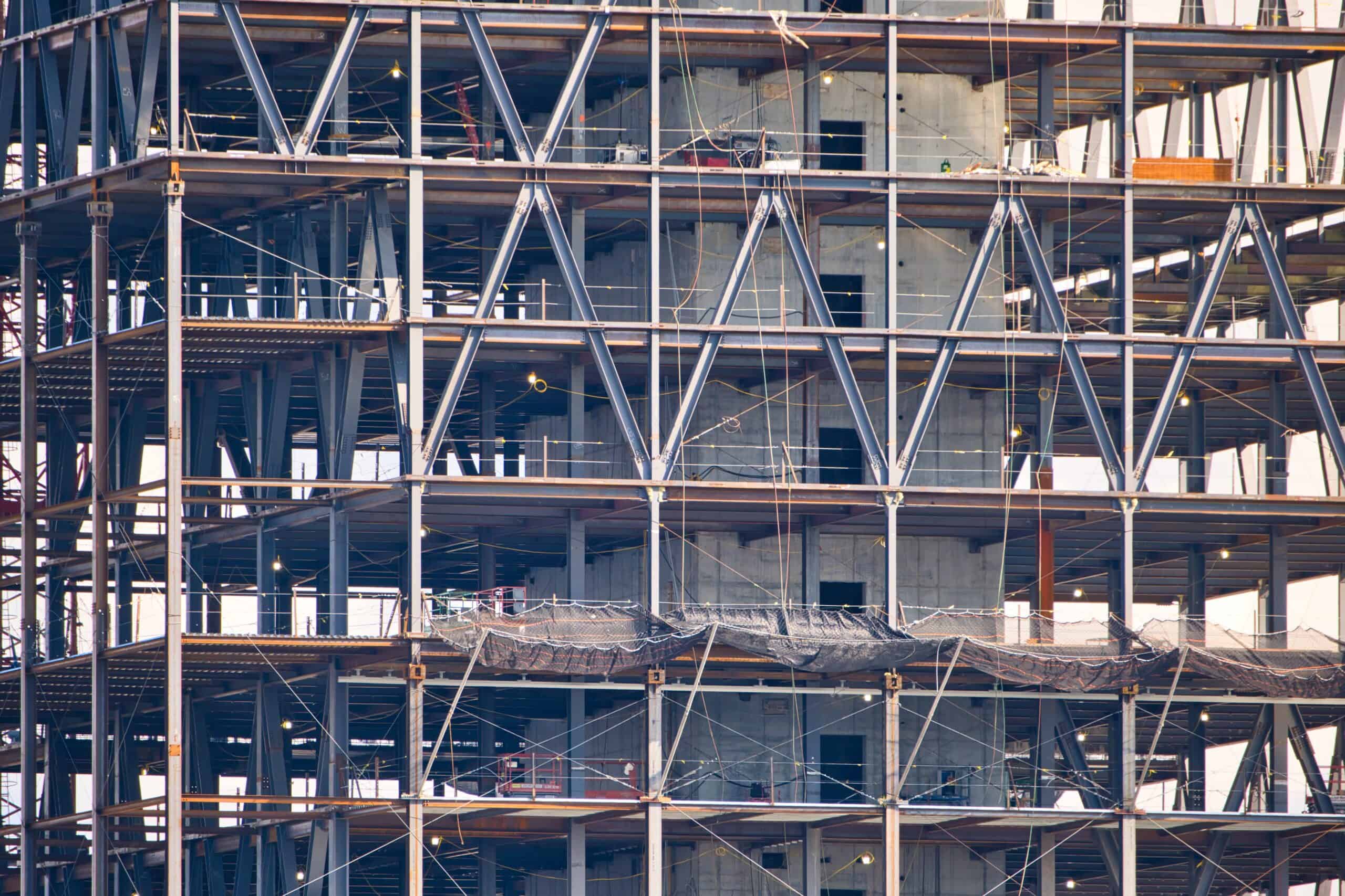 Major commercial building under construction with tower cranes