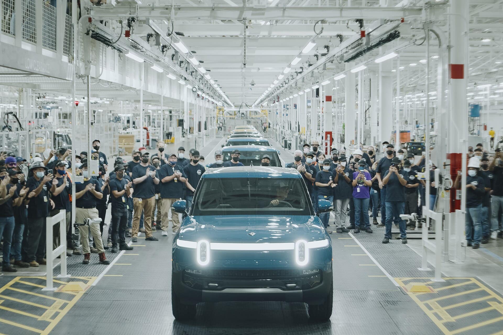 Electric vehicles on the assembly line at a Rivian manufacturing plant.