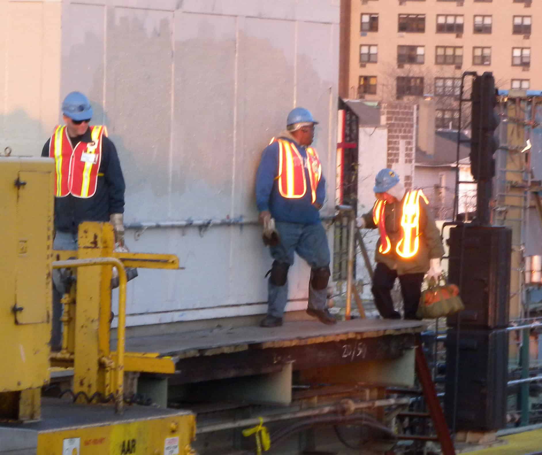 Construction workers in high-visibility safety vests on a jobsite