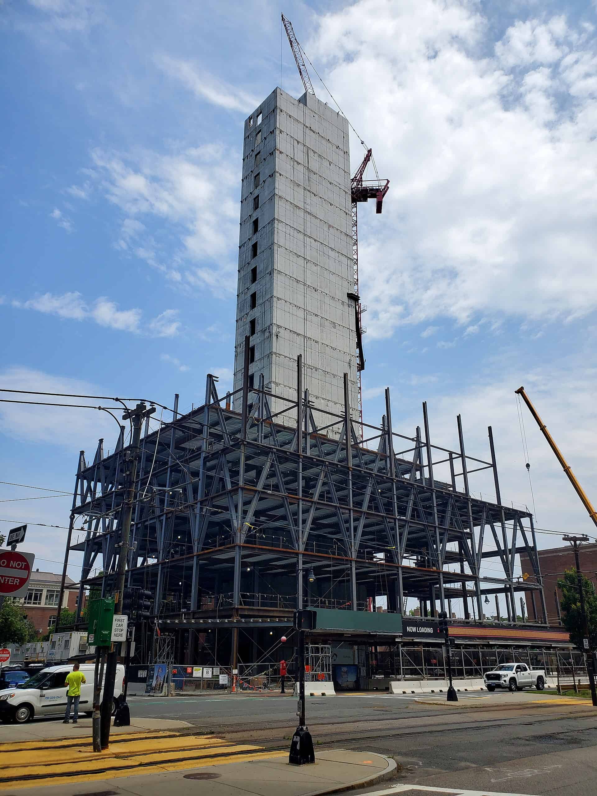 A data sciences building under construction with a tower crane