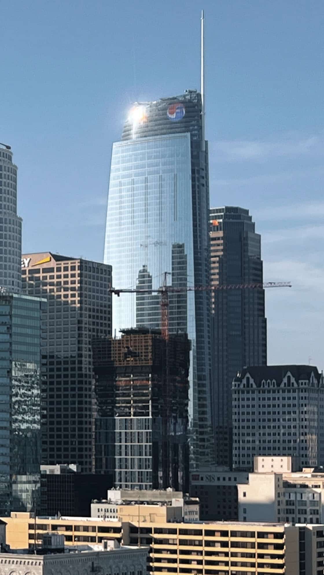 The Wilshire Grand Center tower rising over downtown Los Angeles with its lit crown