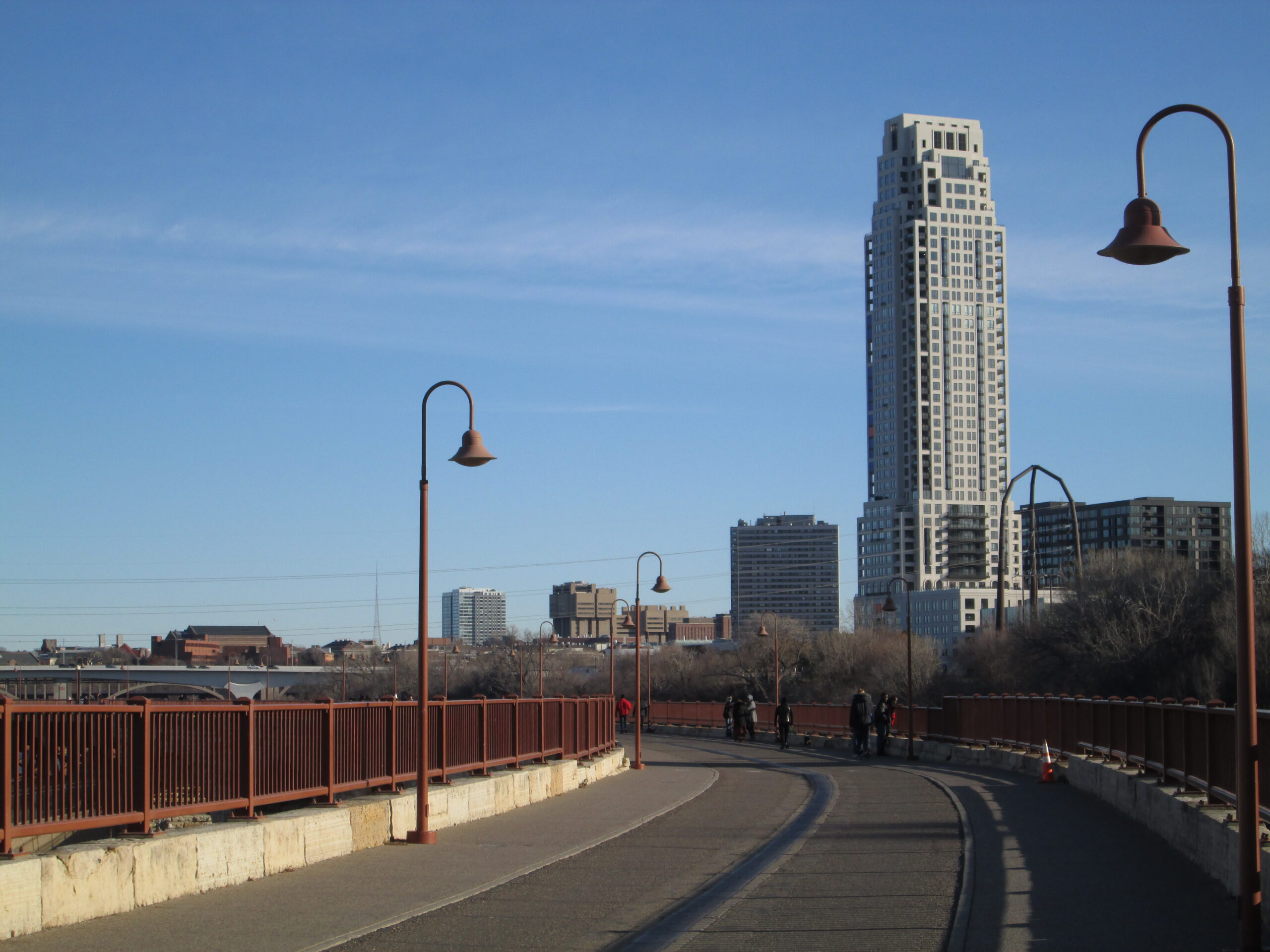 Projects Eleven on the River residential tower seen from the Stone Arch Bridge in Minneapolis