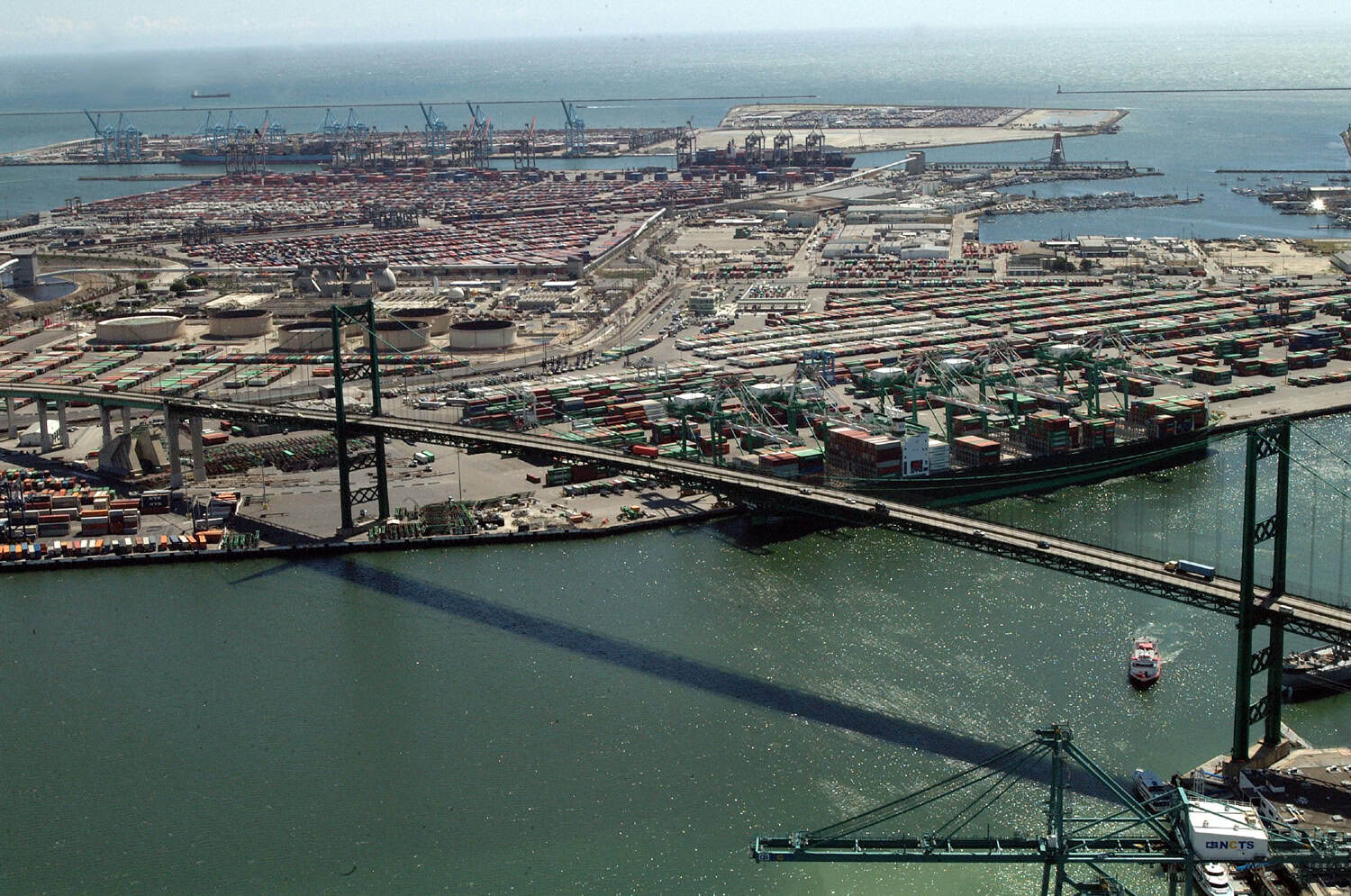Aerial view of the green Vincent Thomas Bridge over the main channel at the Port of Los Angeles