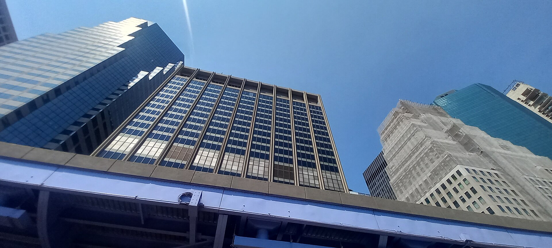 The 1968 office slab at 111 Wall Street in Lower Manhattan seen from street level beside the FDR Drive viaduct