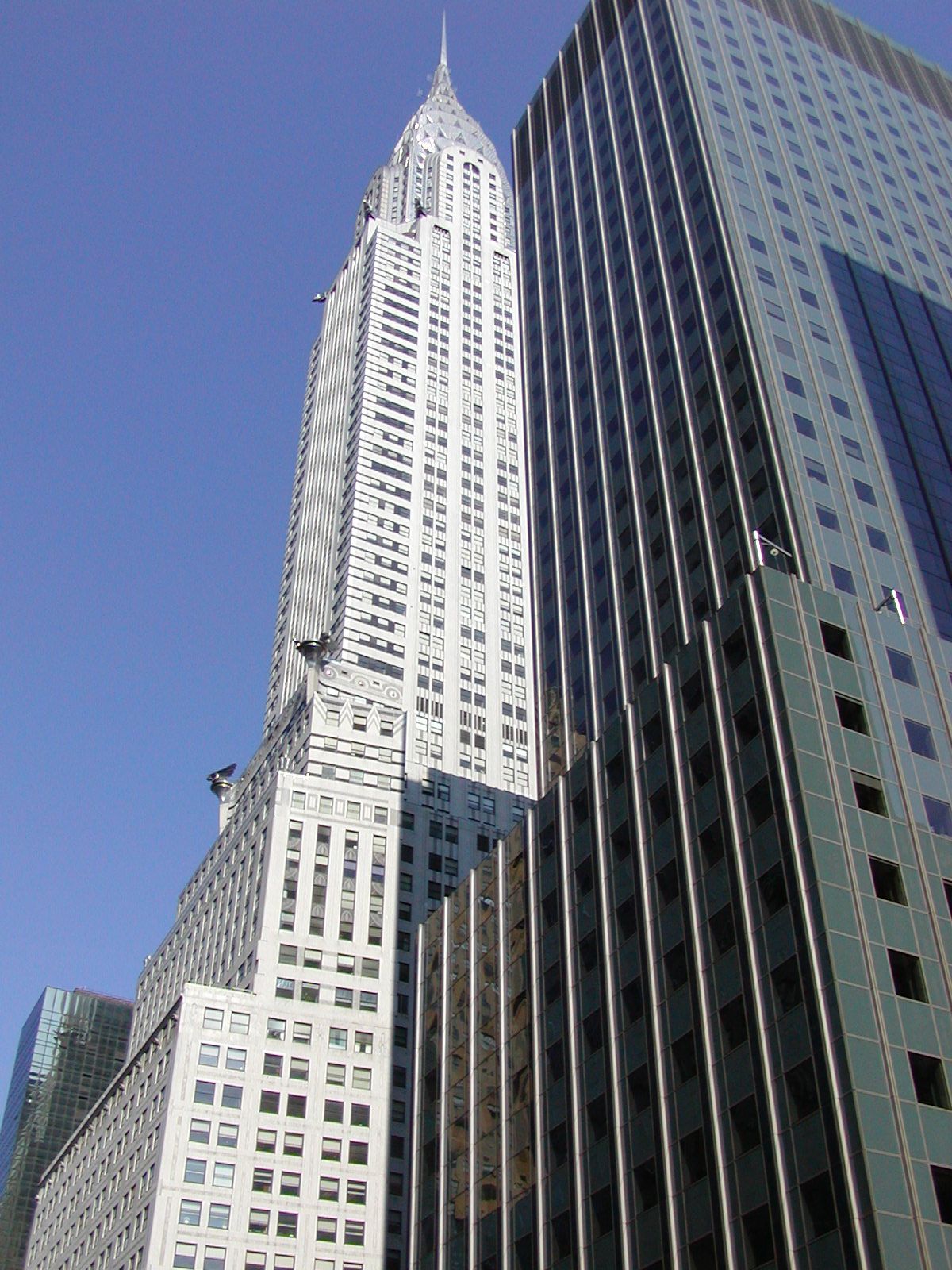 The Chrysler Building's stainless steel crown and spire seen from the east against a blue sky