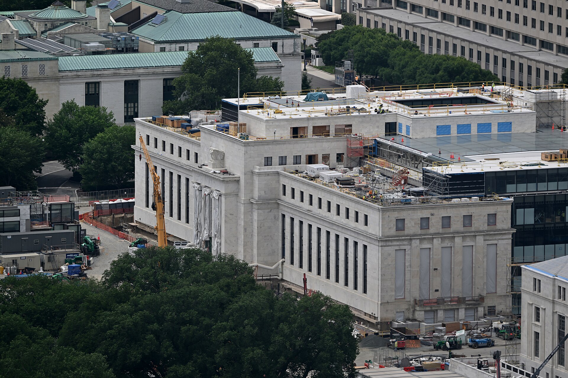 Construction cranes and staging equipment on the roof of the Marriner S. Eccles Federal Reserve Building in Washington DC in June 2026
