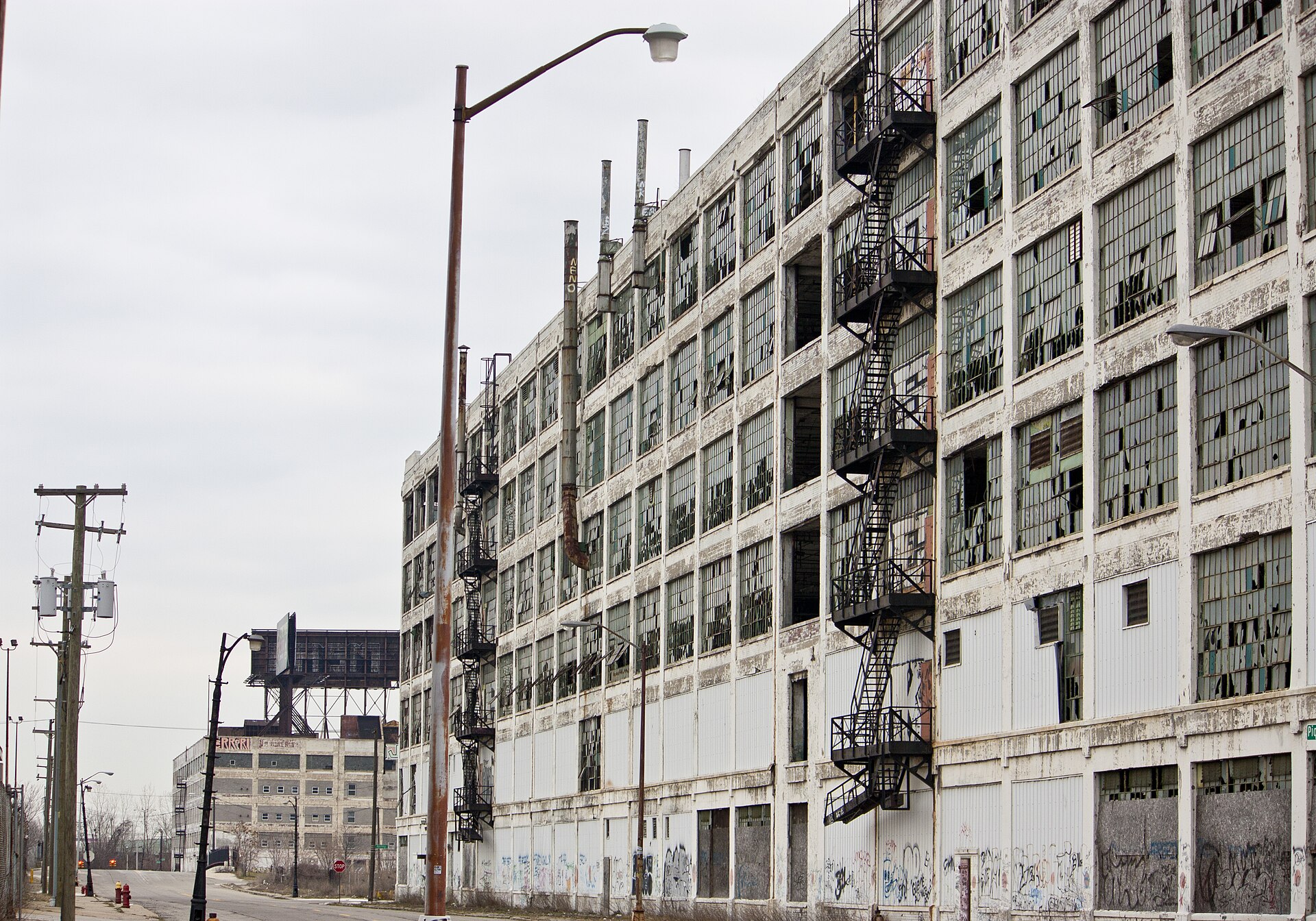 The derelict Fisher Body Plant 21 in Detroit showing its long window-lined facade and fire escapes