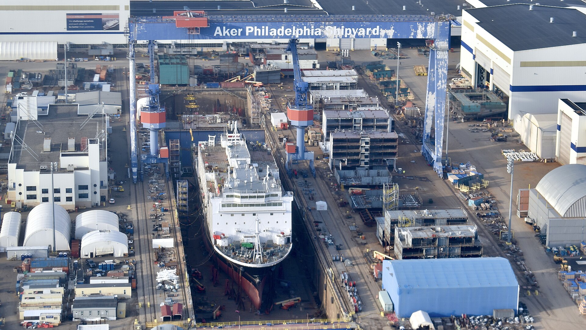 Aerial view of the Philadelphia shipyard with a vessel under construction at the berth