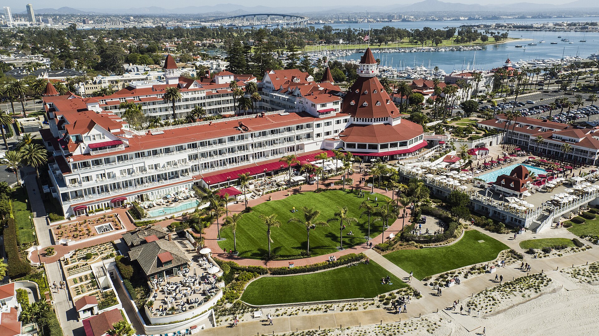 Aerial view of the Hotel del Coronado resort with its red turrets and central lawn on Coronado Island, California