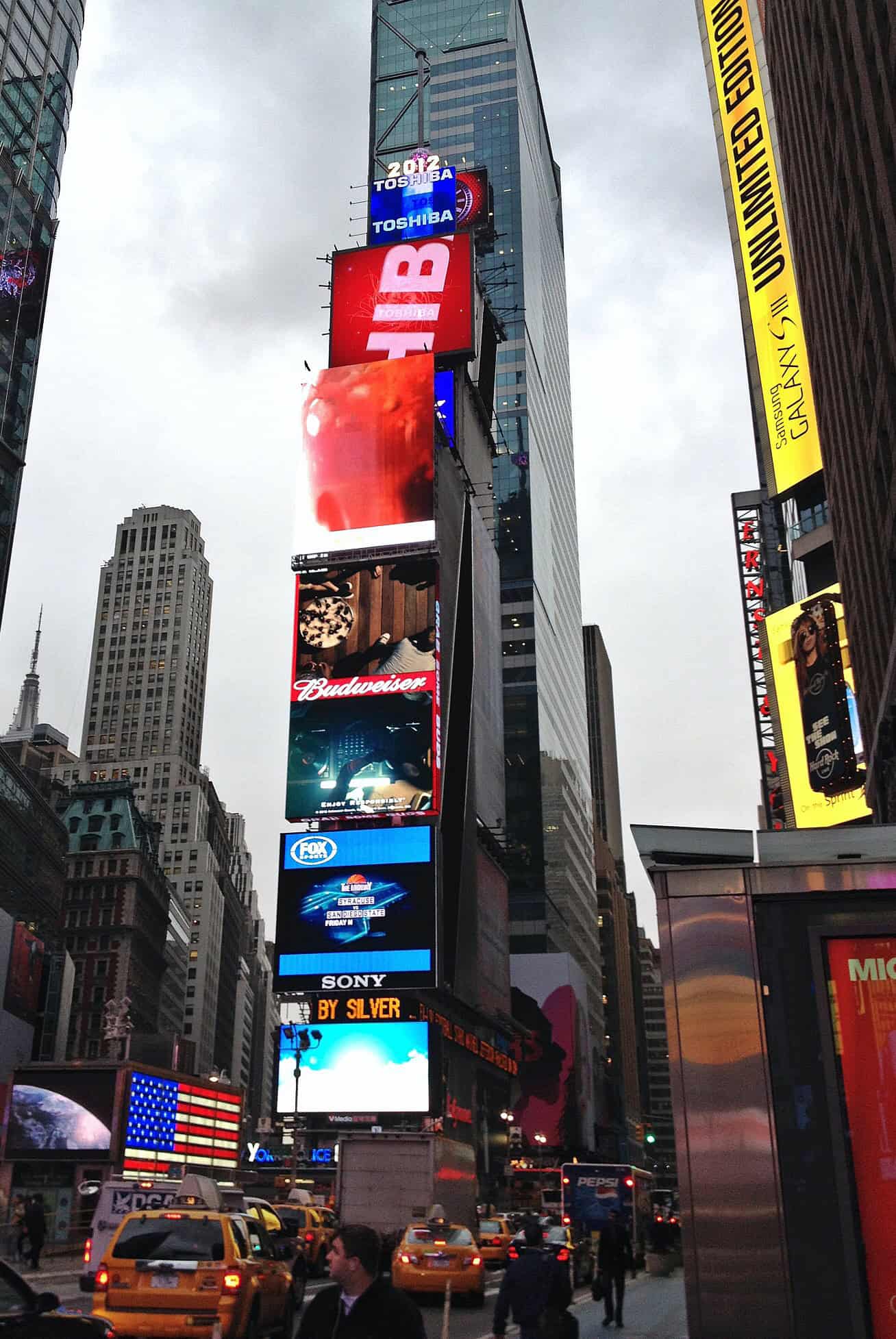 One Times Square clad in illuminated signage at the north end of Times Square, Manhattan