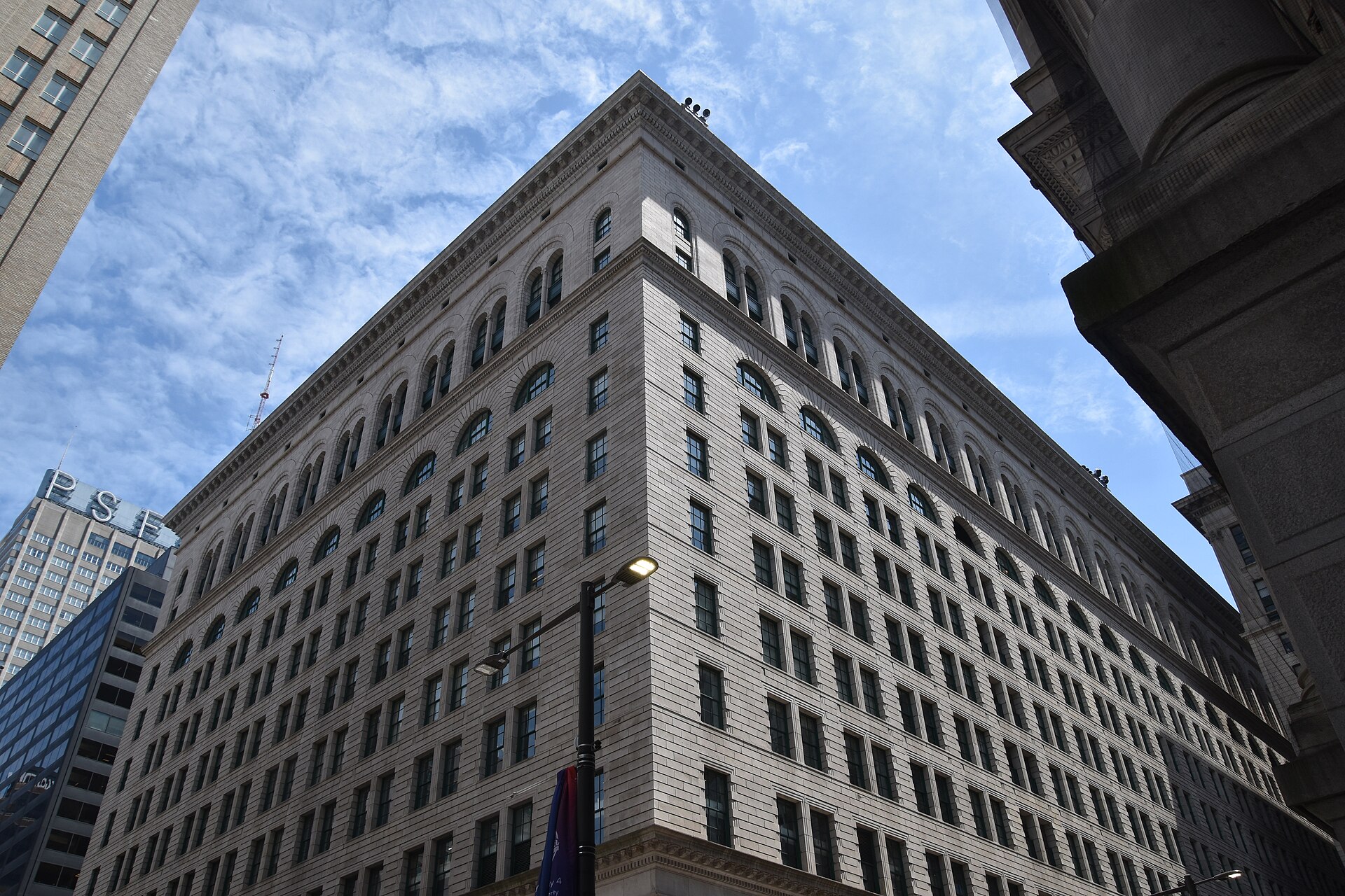 The granite facade of the Wanamaker Building at 1300 Market Street in Philadelphia, seen from street level looking up