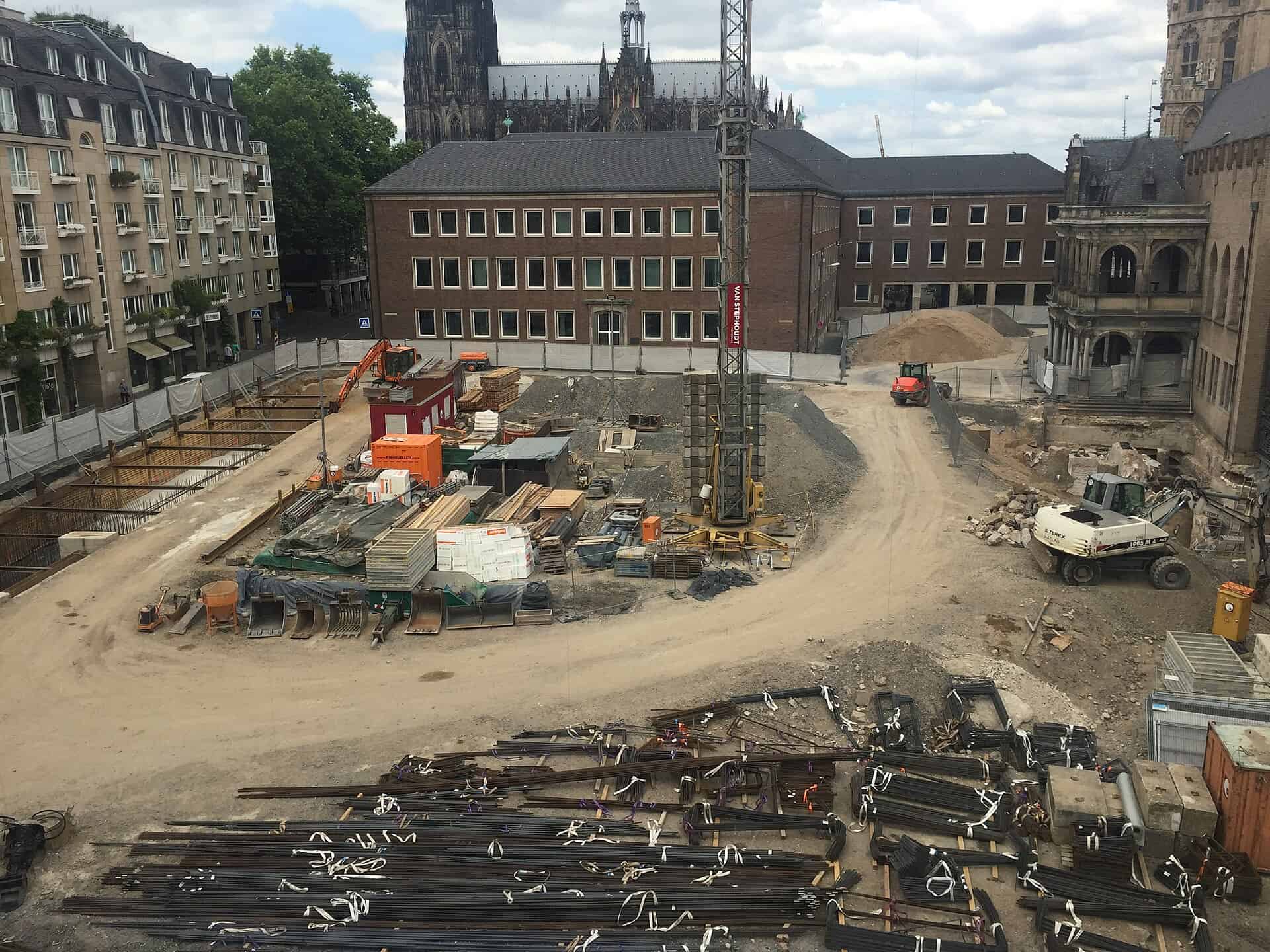 A commercial construction site with tower crane and structural frame