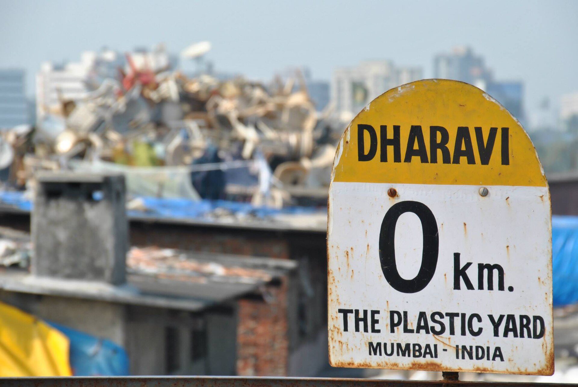 Rooftops and lanes of Dharavi in Mumbai, seen from the elevated road along the settlement's edge
