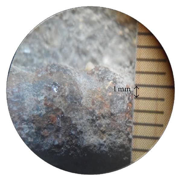Microscope image of corroded steel reinforcement embedded in fly ash concrete