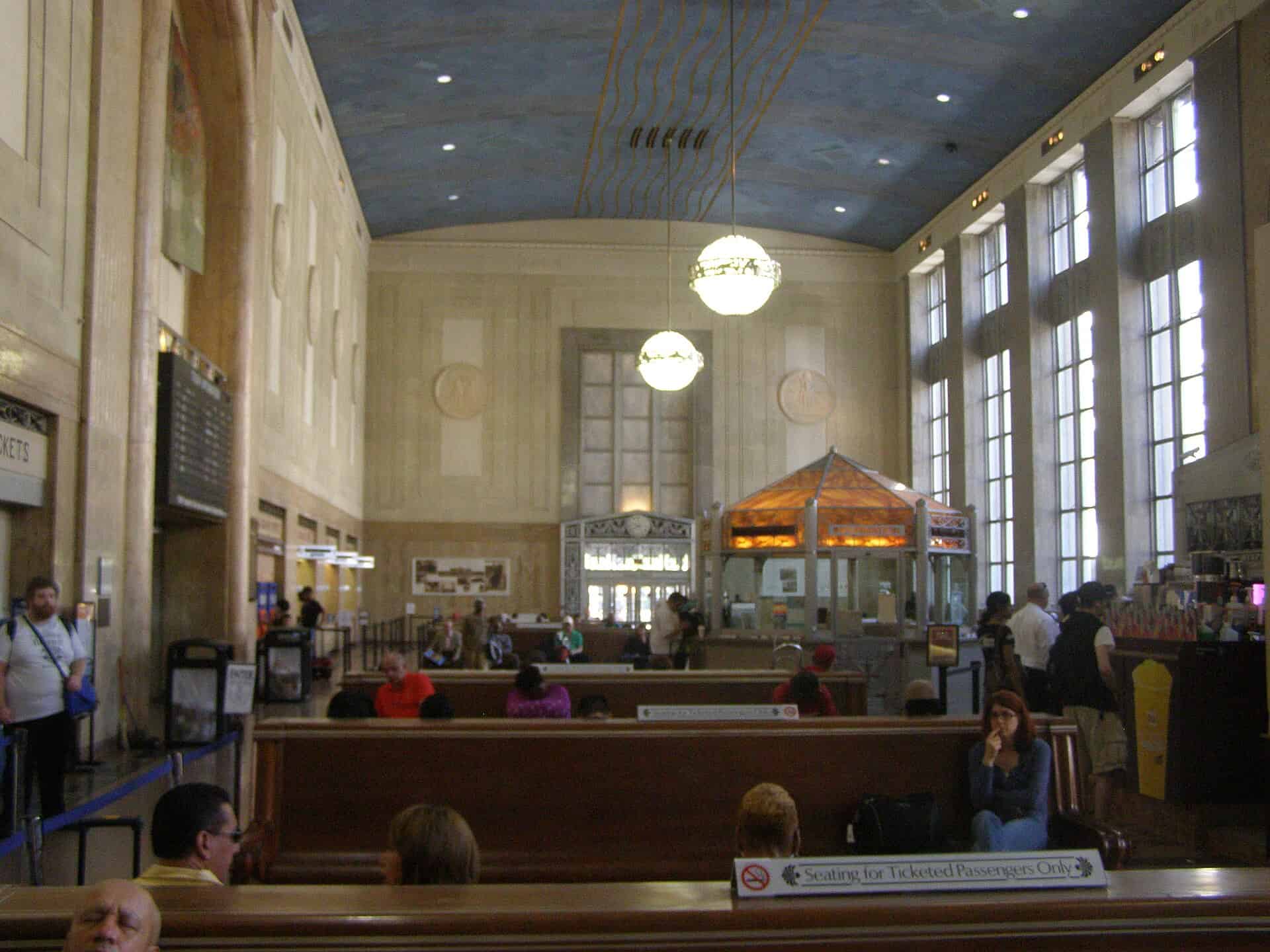 Barrel-vaulted main waiting room at Newark Penn Station with the original Pennsylvania Railroad wooden benches and Art Deco globe pendants