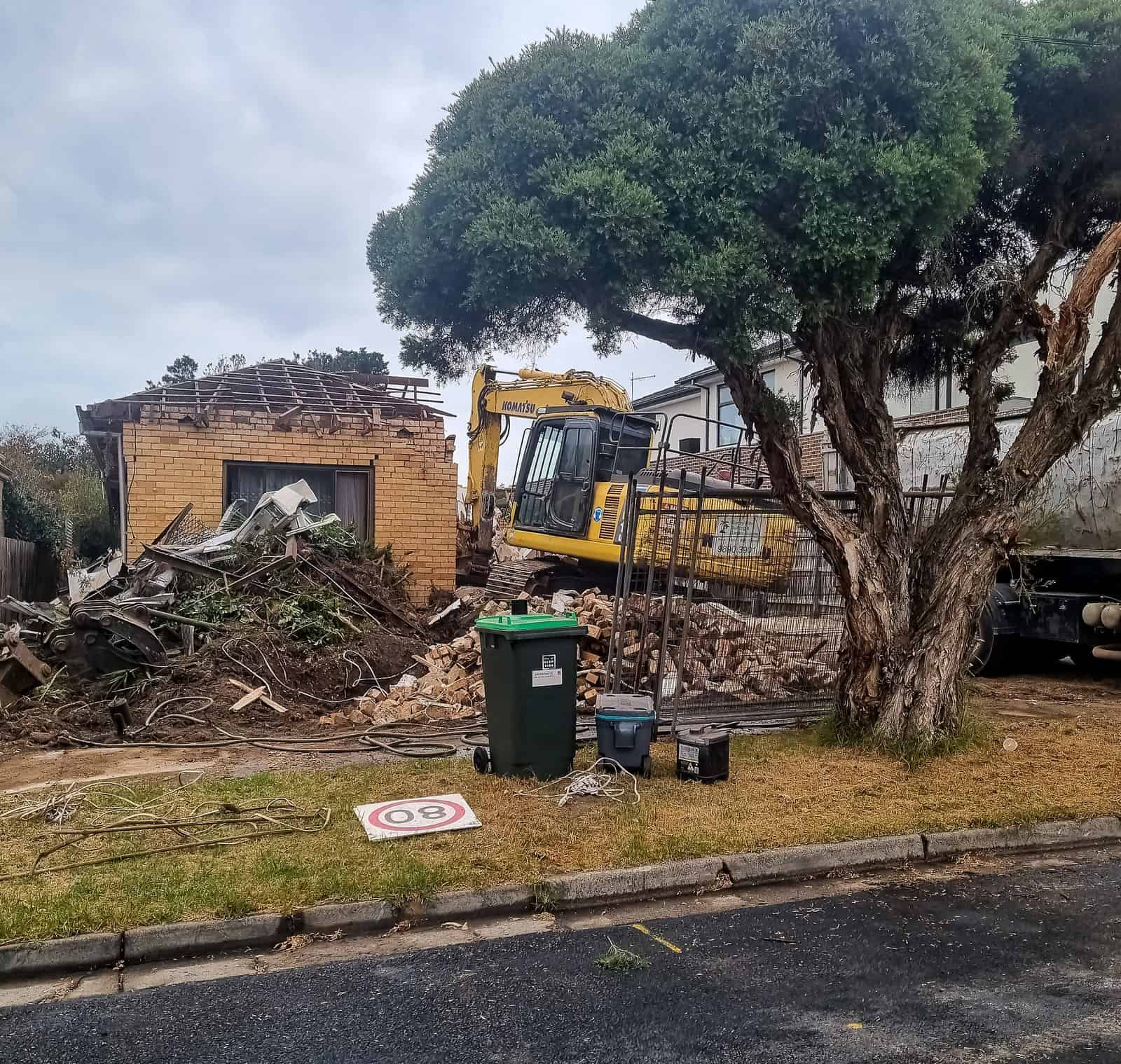 Excavator working through rubble at a building demolition