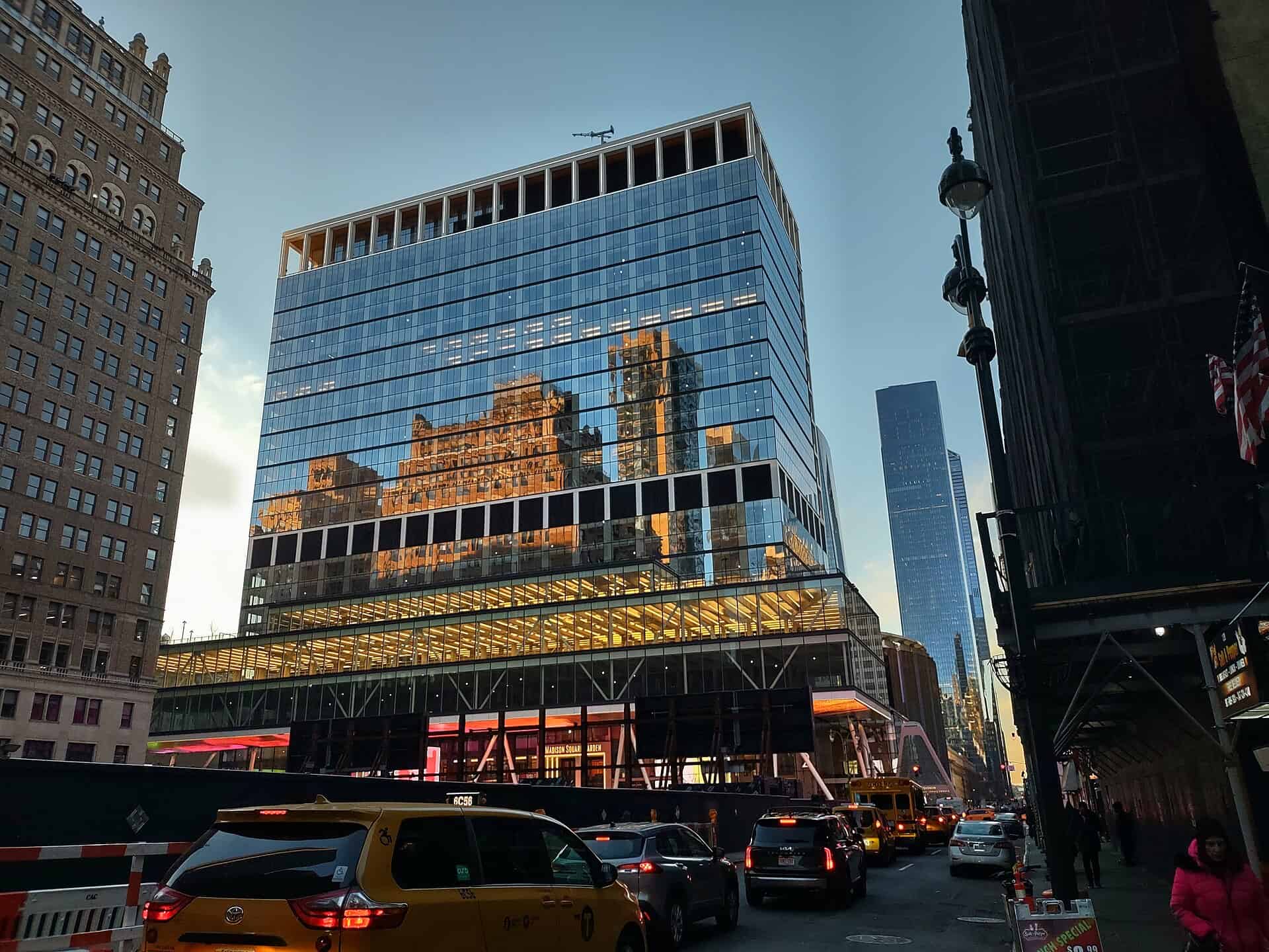 PENN 2 on Seventh Avenue in Manhattan after reskinning, showing the new blue glass curtain wall and the double-height glass podium