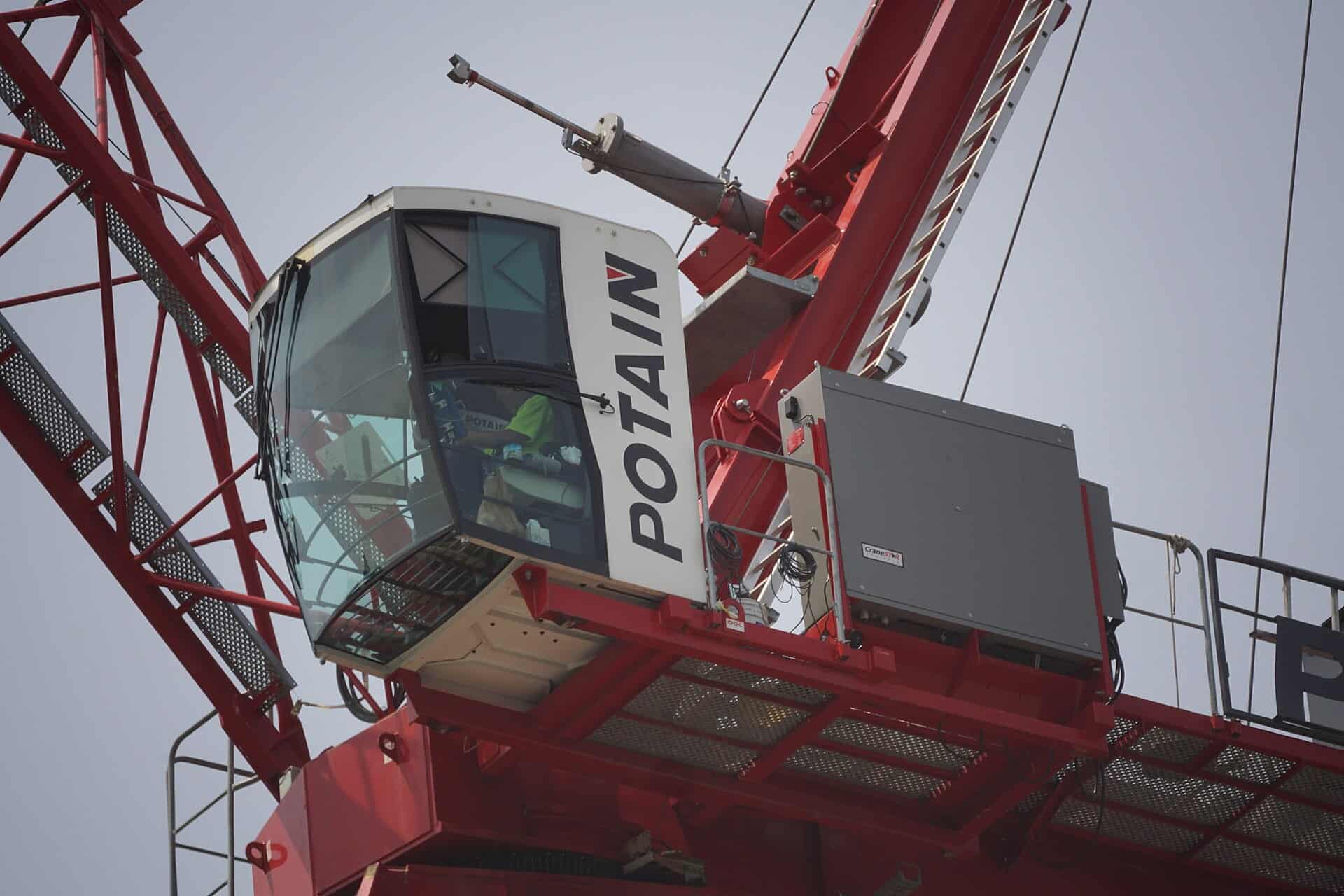 Cab of a Potain tower crane on an active construction site