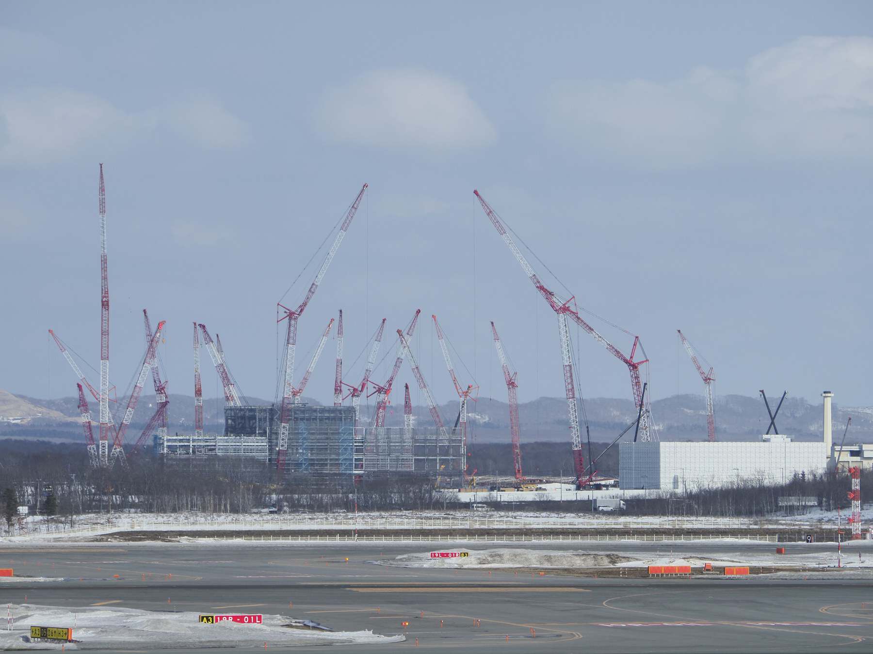 Tower cranes over the Rapidus semiconductor fabrication plant under construction at Chitose, Hokkaido, seen from New Chitose Airport