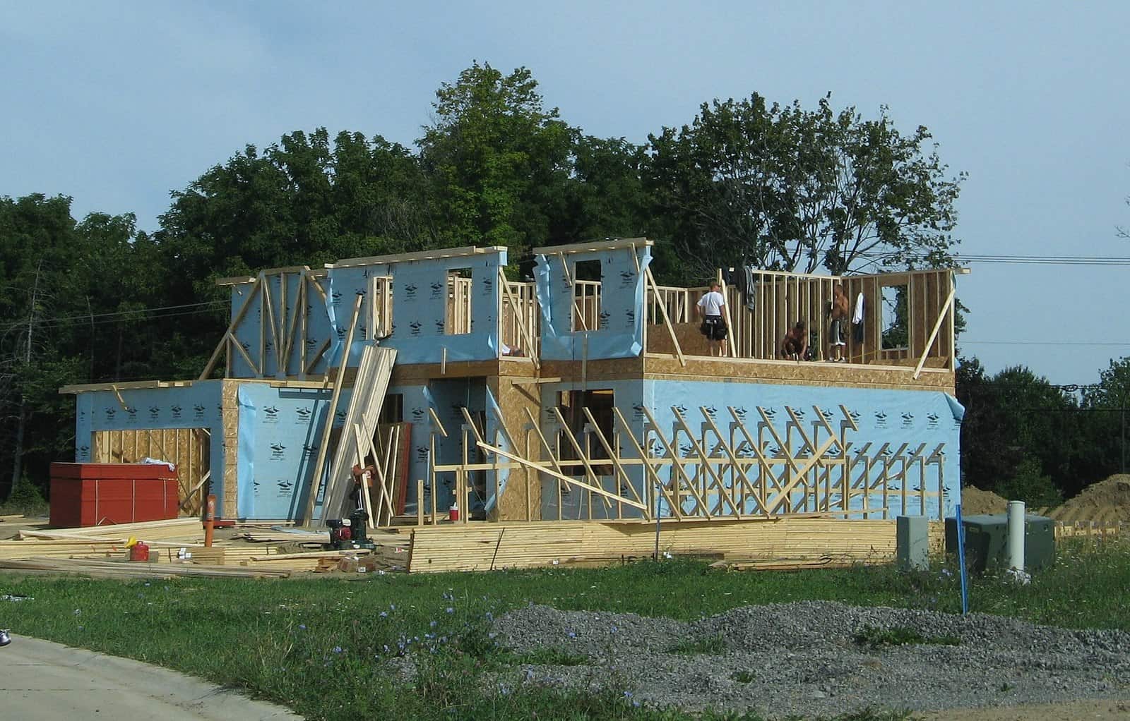 Wood-framed single-family house under construction on a suburban lot