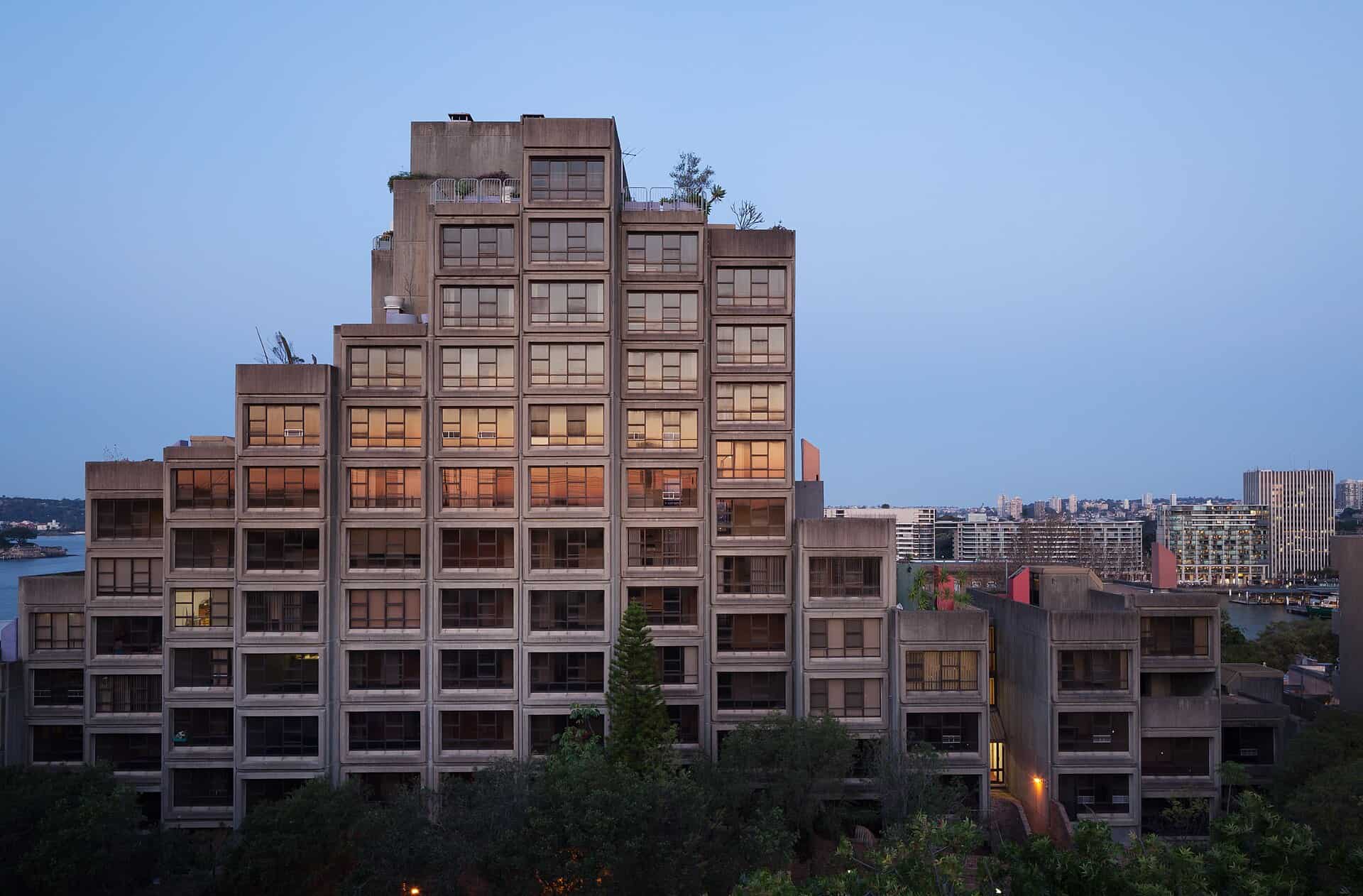 Stepped concrete massing of the Sirius building at The Rocks in Sydney, photographed at dusk