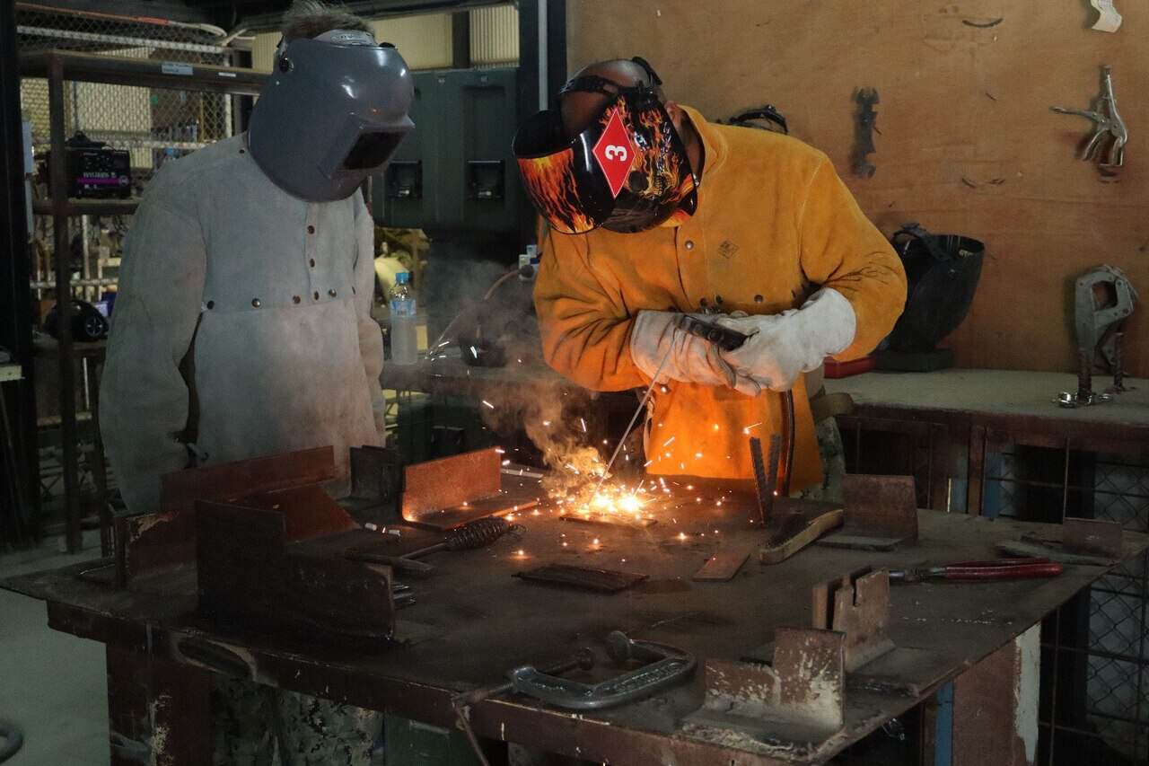 A trainee running a weld bead during a basic welding class