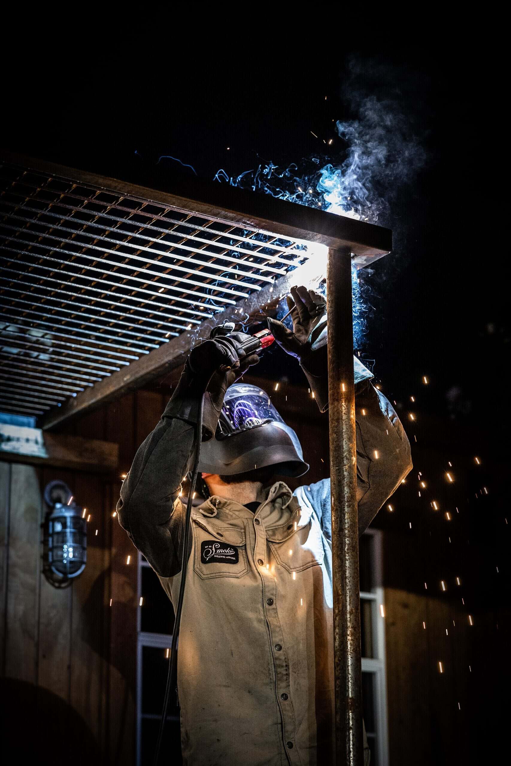 A welder working with shielded metal arc welding equipment