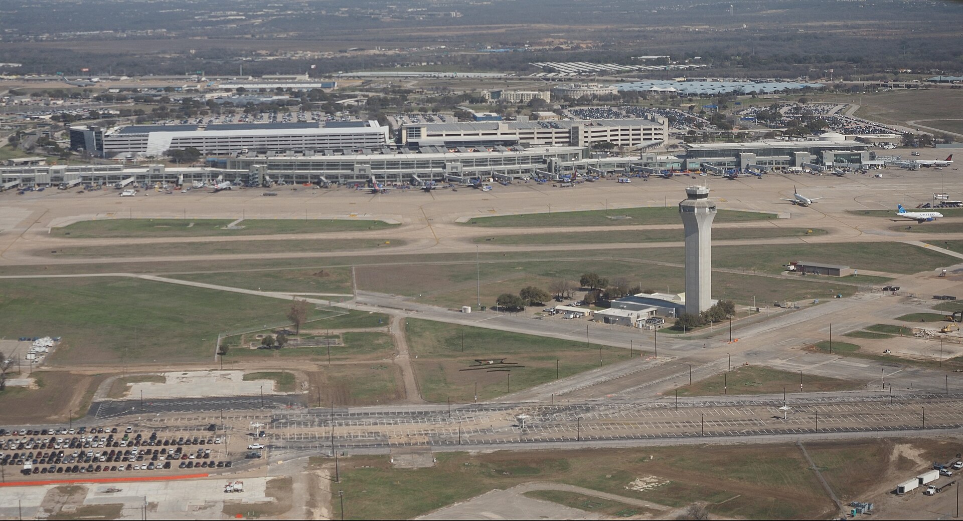Aerial view of Austin-Bergstrom International Airport with the Barbara Jordan Terminal and control tower