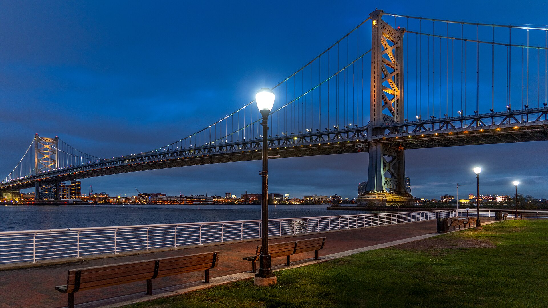 Ben Franklin Bridge suspension span and towers at dusk seen from the Camden waterfront