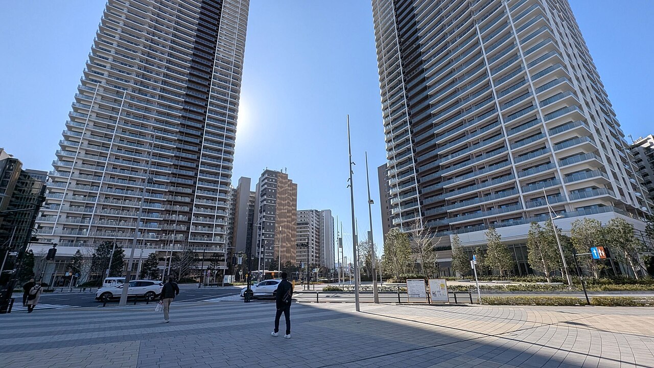 The two completed 50-storey Harumi Flag Sky Duo residential towers in Harumi, Tokyo, seen from street level in January 2026