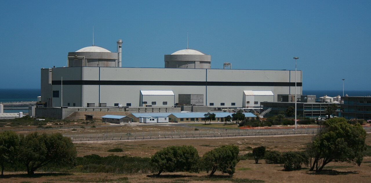 Koeberg Nuclear Power Station near Melkbosstrand, with its two reactor containment domes above the main plant building and the Atlantic Ocean behind