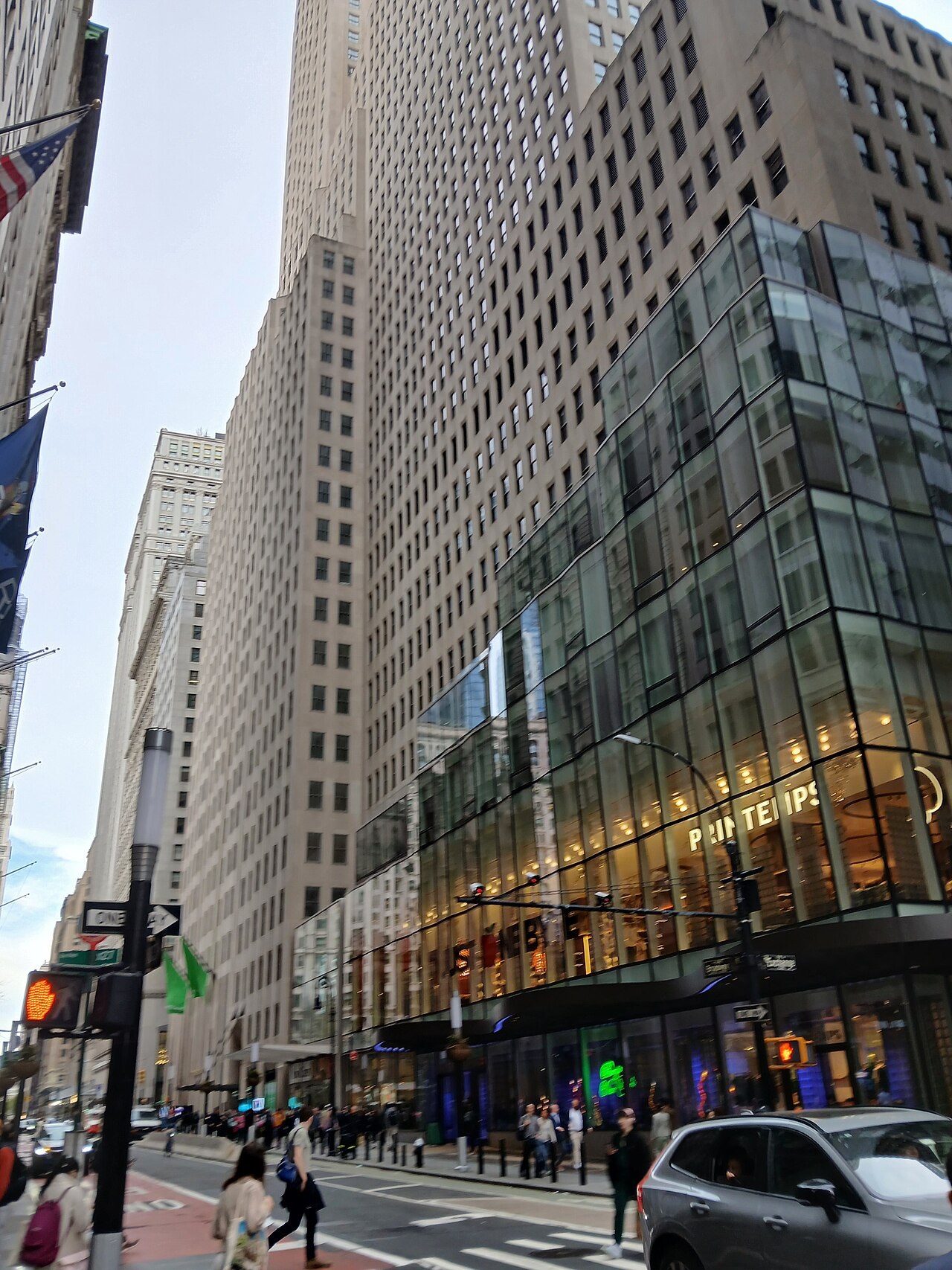 1 Wall Street's limestone Art Deco tower rising above its glass retail addition at Broadway and Wall Street, with the Printemps storefront at street level