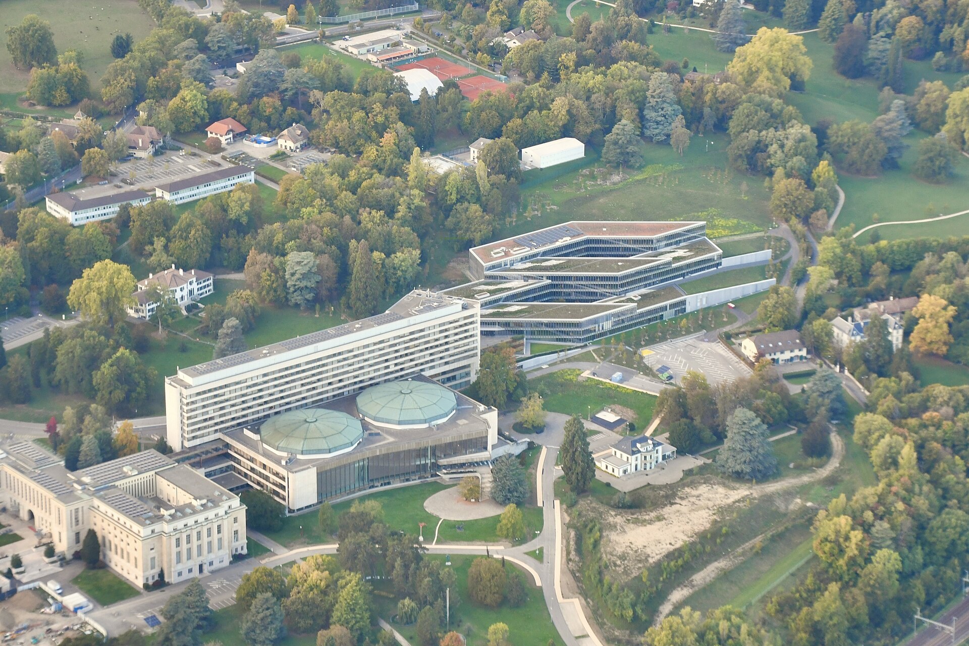 Projects Aerial of the east end of the campus in October 2022: the new terraced Building H, Building E with its office tower and twin domed conference halls, and a corner of the 1930s palace